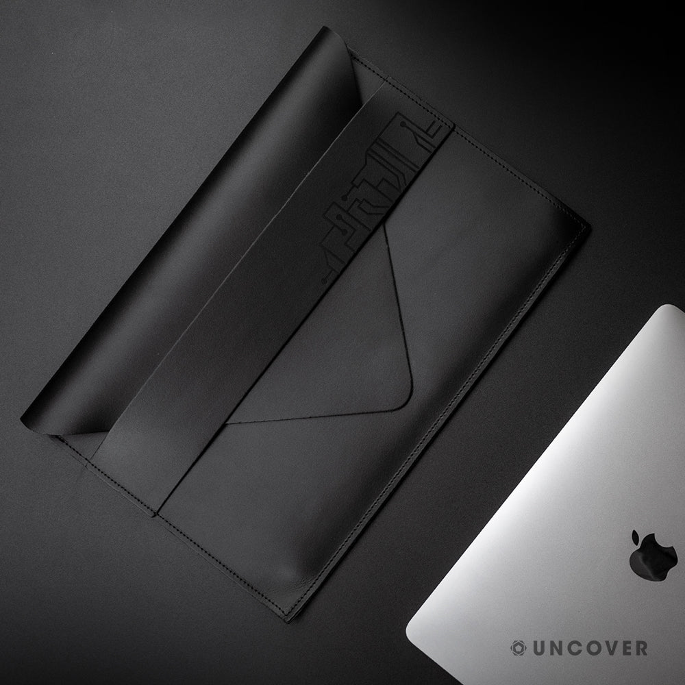 Design your own unique engraving on a black leather laptop sleeve
